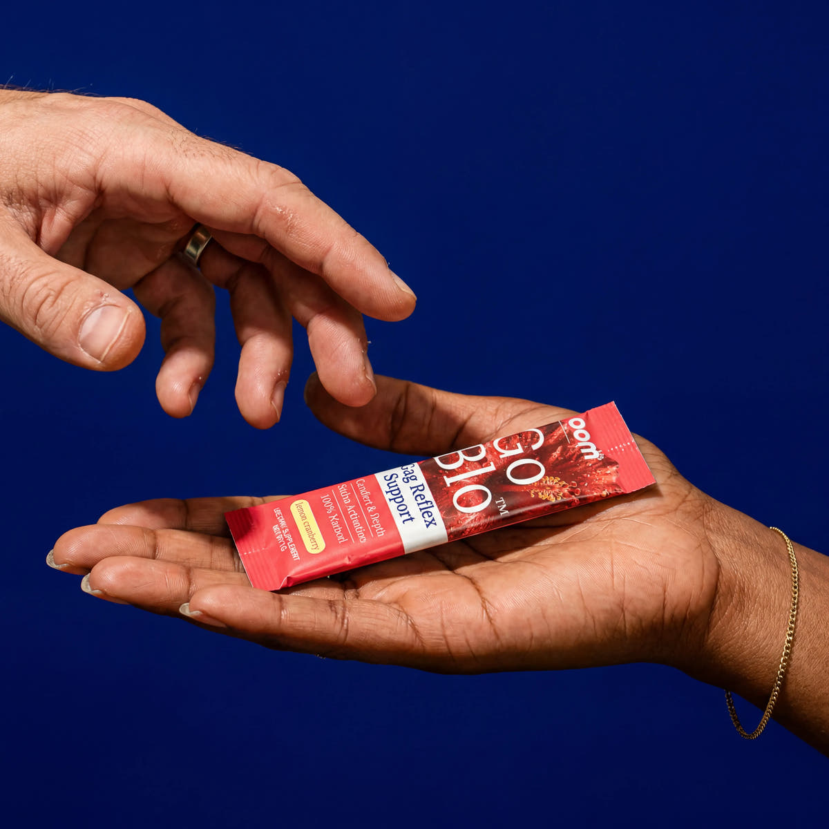 One person handing a GoBlo stick pack to another