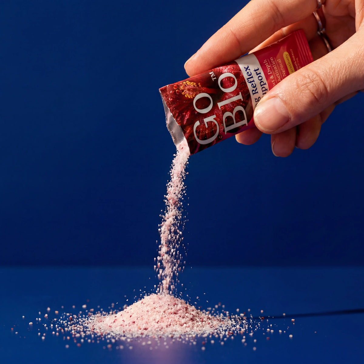 GoBlo lemon-cranberry powder pouring from a stick pack