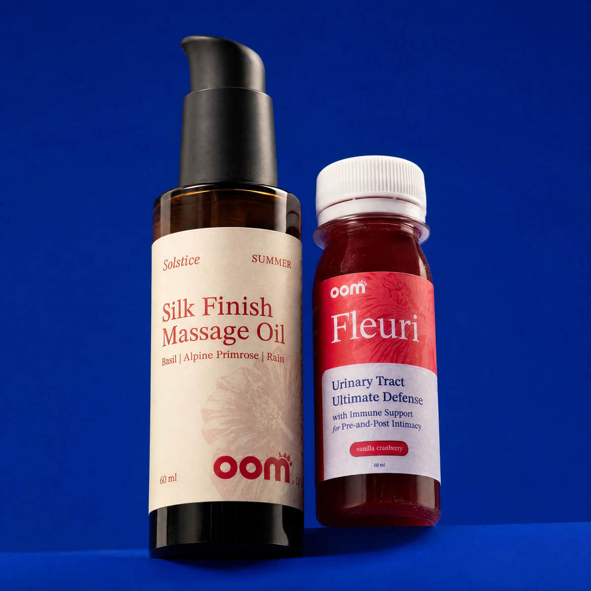 Solstice massage oil and Fleuri shot together on a Klein blue background